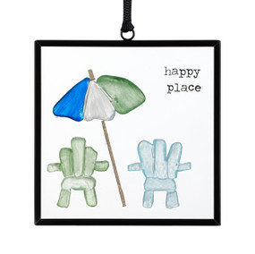 A small square suncatcher with two beach chairs and a sun umbrella made out of small colored blue and green stones and the saying "happy place".