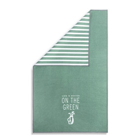 A green and white double sided towel that has the saying "Life is Better on the Green". The towel is turned over at a corner showing the green and white striped back.