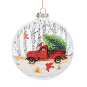 A round disc ornament with the image of a red truck with a tree in the back.