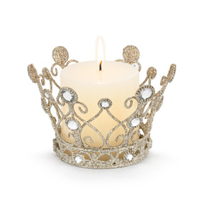 A gold sparkly crown shaped candle holder with silver beads, displayed with a lit candle inside.