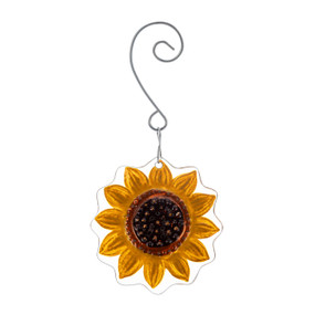 A glass ornament of a yellow and brown sunflower hanging from a curved silver hanger.