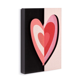 A black and light pink acrylic wall art tile with an illustrated heart in shades of pink and red displayed angled to the right.