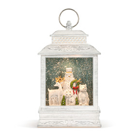 A white lit musical lantern with the image of a snowman with woodland winter white animals.