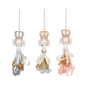 Three different nutcracker ornaments made out of different colored ribbon tassels.