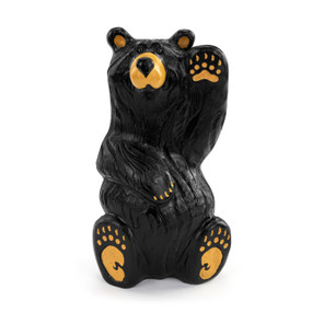 A large figure of a black bear sitting down and waving with one paw.