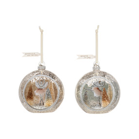 Two different open round ornaments with a ballerina inside dancing in a silver and gold glittery forest.