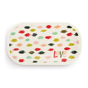 A white rectangular melamine platter with the word "Love" in the bottom right corner and red and green scribbles scattered over the platter.