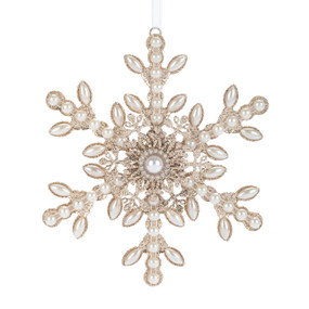 A snowflake ornament made of white beads and gold glitter.