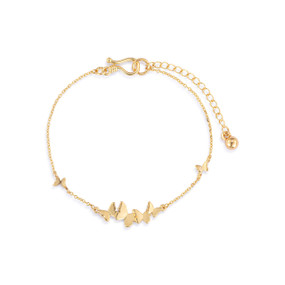 An adjustable gold chain bracelet with a small cluster of gold butterflies.