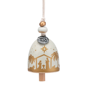 A small cream and gold bell with an image of the holy family and a silver token at the top with a heart.