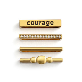 Four different gold charms that fit on a smart watch band. One has the word "courage".