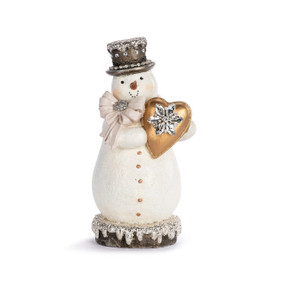 A white snowman figure where he is holding gold heart with a silver snowflake. The snowman is decorated with silver glitter and beads.