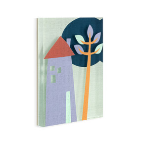 A light green acrylic wall art tile with an illustrated blue home next to a tall leafy tree displayed angled to the right.