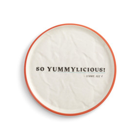A white crinkly melamine plate with an orange rim. The saying "So Yummylicious!" is in the middle.