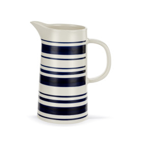 A white ceramic pitcher with dark blue horizontal stripes and a handle.