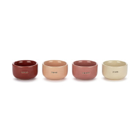 A set of four small ceramic pinch bowls in different pink colors. Each has a different word on the front including xoxo, love, sweet and yum.