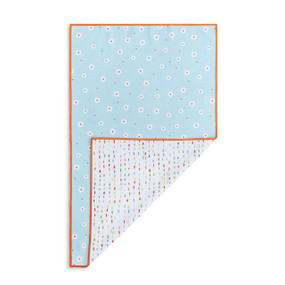A rectangular double sided towel. One side is light blue with small white daisies and the other is white with small colored lines, displayed with the white corner turned back.