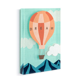 A light blue acrylic wall art tile with an illustrated orange hot air balloon over the mountains with the word "Dream" displayed angled to the right.