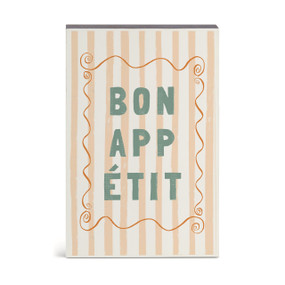 A wall art with cream and peach vertical stripes and the saying "Bon Appetit".