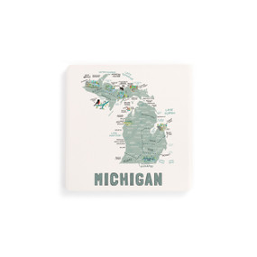 A set of four white square coasters with a map illustration of Michigan with famous landmarks and cities.