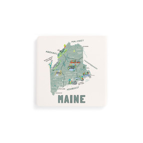 A set of four white square coasters with a map illustration of Maine with famous landmarks and cities.
