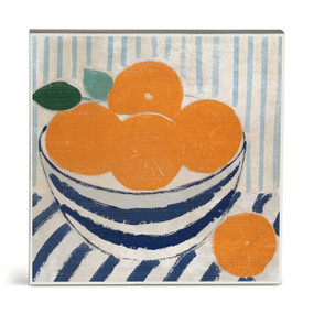 A square illustrated wall art of oranges in a blue and white striped bowl.