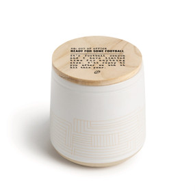 A white ceramic jar candle. The lid is wood with the saying "RE: Out of the Office Ready for some football" with a short write up about someone not working due to watching football.