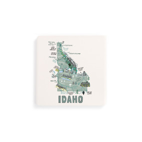A set of four white square coasters with a map illustration of Idaho with famous landmarks and cities.