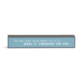 A blue rectangular wall art with the saying "The Only Thing On My Bucket List is to Make It Through the Day." in white.