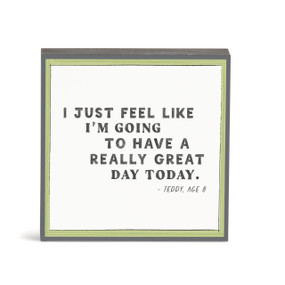 A white wall art with the saying "I Just feel like I'm going to have a really great day today."