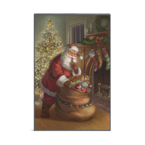 A rectangular wall art of Santa with his bag of toys in a living room setting.