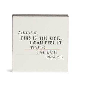 A white wall art with the saying "AHHHHH, This is the life...I can feel it. This is the life."