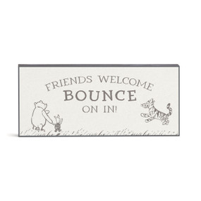 A wall art with images of Pooh, Piglet and Tigger with the saying "Friends Welcome Bounce On In".