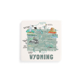 A set of four white square coasters with a map illustration of Wyoming with famous landmarks and cities.