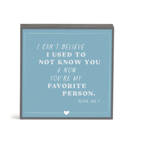 A blue wall art with the saying "I can't believe I used to not know you & now you're my favorite person."