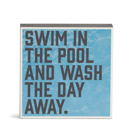 A blue wall art with the saying "Swim in the pool and wash the day away".