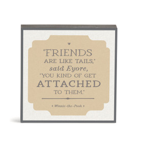 A white and brown Winnie the Pooh themed wall art with a saying about friendship.