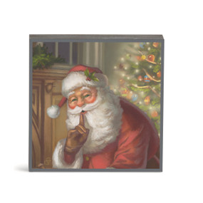 A square wall art with an image of Santa in a living room signaling to be quiet.