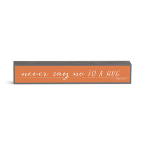 An orange rectangular wall art with the saying "never say no to a hug".