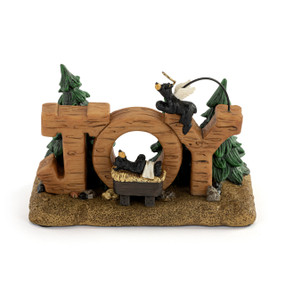 A figurine of the word "Joy" with a baby black bear in a manger inside the "O" and an angel bear on top of the "Y".