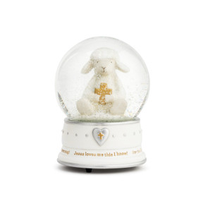 An ivory snowglobe, with silver and gold accents, such as dots and a heart, and has a message about Jesus at the bottom. Filled with glitter and lamb holding a gold cross.