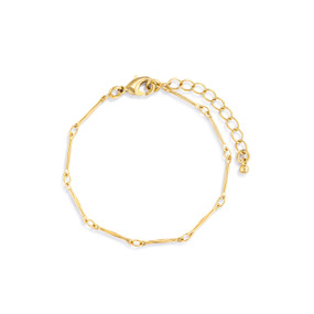 Detail view of the links on a gold chain bracelet with bar links. The bracelet is waterproof.