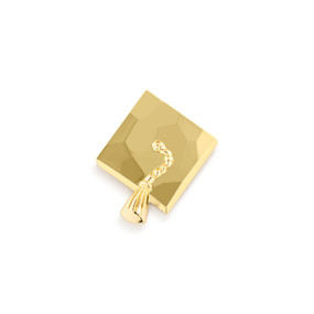 Top down view of a gold graduation cap magnet.