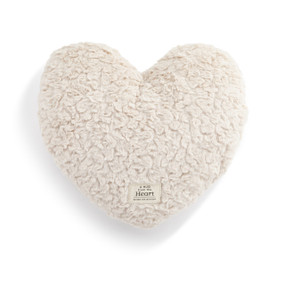 Top down view of a cream heart shaped weighted pillow. A patch at the bottom of the heart, reads "A hug from the heart."