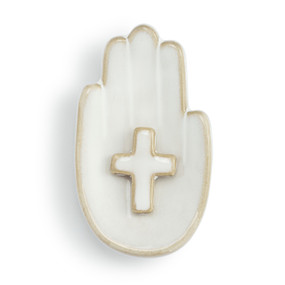 Top down view of a white ceramic trinket dish. The dish is a palm up right hand with a cross at the center of the palm.