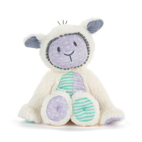 Front view of a white plush lamb. The lamb's face, right side of the chest, paw and left foot have purple polka dot fabric. Its left paw,  right foot and the left side of the chest have green striped fabric.