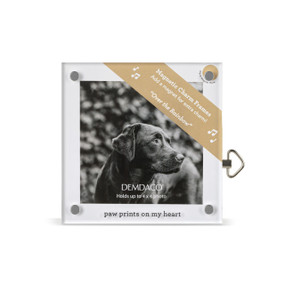 Top down view of a square acrylic musical frame with magnets in each corner. "Paw prints on my heart" is printed at the bottom. A brown banner in the upper right corner indicates the music box plays "Over the Rainbow".