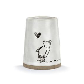 Front facing view of of a white ceramic vase with an illustration of Winnie the Pooh looking up at a butterfly.
