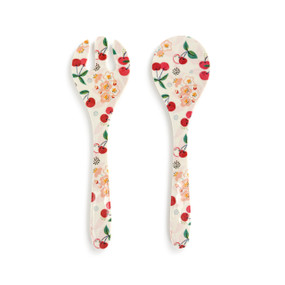 Top down view of a melamine serving utensil set. The surfaces are decorated with a print of cherries and green leaves.The utensils, a spoon and slotted spoon, are set out side by side.