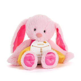 Front view of a plush pink bunny wearing a dark pink bodice and yellow tutu. The bunny has a necklace card on its lap, holding a gold necklace with a dancer charm. "Dance!" is printed at the top of the card, above the necklace.
